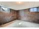 Unfinished basement space with natural light from two windows, offering potential for customization at 2525 S Ivanhoe Pl, Denver, CO 80222