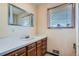 Bathroom features a sink and mirror with natural light from a window at 2525 S Ivanhoe Pl, Denver, CO 80222