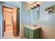 A full bathroom featuring a sink, mirror, and tiled shower at 2525 S Ivanhoe Pl, Denver, CO 80222