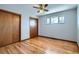 A bedroom featuring wood floors, closet doors, and a ceiling fan at 2525 S Ivanhoe Pl, Denver, CO 80222