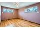 A bedroom with a ceiling fan and two windows with natural light at 2525 S Ivanhoe Pl, Denver, CO 80222