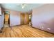 View of a bedroom with ceiling fan, wood floor, and multiple doorways at 2525 S Ivanhoe Pl, Denver, CO 80222