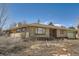 Charming brick home with large windows and attached garage under a clear blue sky at 2525 S Ivanhoe Pl, Denver, CO 80222