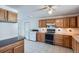 The kitchen features oak cabinets, tile flooring, laundry and appliances at 2525 S Ivanhoe Pl, Denver, CO 80222