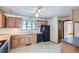 The kitchen features light wood cabinets, white backsplash tiles, and black appliances at 2525 S Ivanhoe Pl, Denver, CO 80222