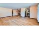 Open-concept living room with hardwood floors that leads to a kitchen and dining area at 2525 S Ivanhoe Pl, Denver, CO 80222
