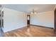 View of a living room with hardwood flooring, a light fixture, and an entry door at 2525 S Ivanhoe Pl, Denver, CO 80222