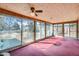 Bright sunroom featuring expansive windows, a wood plank ceiling, and pink carpet flooring, great for relaxing at 2525 S Ivanhoe Pl, Denver, CO 80222
