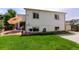 Well maintained backyard with a lush lawn, patio seating, and a white two-story house at 11883 W Marlowe Pl, Morrison, CO 80465