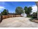 Spacious backyard featuring a large concrete area, a storage shed, and a sturdy wooden fence at 11883 W Marlowe Pl, Morrison, CO 80465
