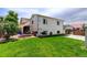 Spacious backyard with lush green grass and a patio area perfect for entertaining at 11883 W Marlowe Pl, Morrison, CO 80465