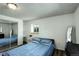 Bedroom with wood floors, a sliding door closet, and a bed with blue patterned comforter and pillows at 11883 W Marlowe Pl, Morrison, CO 80465