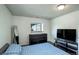 Bedroom with wood floors, a small window, and a bed with blue patterned comforter and pillows at 11883 W Marlowe Pl, Morrison, CO 80465
