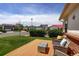 Inviting front yard with a cozy deck area, comfortable seating, and lush green surroundings at 11883 W Marlowe Pl, Morrison, CO 80465