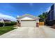 The home's garage and driveway are accented by well-maintained landscaping and greenery at 11883 W Marlowe Pl, Morrison, CO 80465