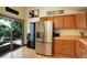 Well-lit kitchen with stainless steel appliances and wood cabinets at 11883 W Marlowe Pl, Morrison, CO 80465
