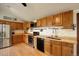 Bright kitchen with stainless steel appliances, plenty of cabinetry, and butcher block counters at 11883 W Marlowe Pl, Morrison, CO 80465