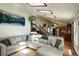 Open-concept living room features a large sectional sofa, wood floors, and seamless flow into the dining and kitchen areas at 11883 W Marlowe Pl, Morrison, CO 80465