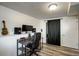 Office area with wood floors, a desk, a guitar on the wall, and black out curtains at 11883 W Marlowe Pl, Morrison, CO 80465