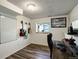 Office space with hardwood floors features guitars on the wall, a desk, and a whiteboard at 11883 W Marlowe Pl, Morrison, CO 80465