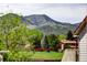 Scenic view capturing houses nestled amidst lush trees and the backdrop of majestic mountains at 11883 W Marlowe Pl, Morrison, CO 80465