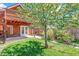 Spacious backyard with mature tree and a patio providing an outdoor seating area at 3513 Quitman St, Denver, CO 80212