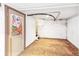 Unfinished basement with brick wall, carpet, and door at 3513 Quitman St, Denver, CO 80212