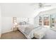 Bright bedroom features a ceiling fan, gray carpet, and a sliding glass door to a deck at 3513 Quitman St, Denver, CO 80212