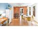 Charming dining room featuring exposed brick, hardwood floors, and natural light, perfect for Gathering meals at 3513 Quitman St, Denver, CO 80212