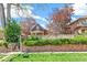 Exterior view of a charming home with a brick facade, surrounded by lush greenery and a well-maintained lawn at 3513 Quitman St, Denver, CO 80212