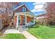 Charming home with a brick exterior, a cozy front porch, and a well-maintained lawn at 3513 Quitman St, Denver, CO 80212