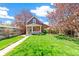 Quaint home featuring a well-manicured front lawn and a welcoming entrance with a cozy front porch at 3513 Quitman St, Denver, CO 80212