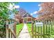 Charming brick home with a well-maintained front yard and a wooden fence with an inviting walkway leading to the front porch at 3513 Quitman St, Denver, CO 80212