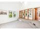 The living room showcases built-in shelves, large windows, and carpet flooring at 3513 Quitman St, Denver, CO 80212