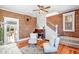 Cozy living room showcasing exposed brick walls, hardwood floors, and an open staircase, filled with natural light at 3513 Quitman St, Denver, CO 80212