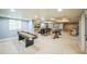 Finished basement area with a shuffleboard table, a bar with stools, and tables with chairs at 1261 W 170Th Ave, Broomfield, CO 80023
