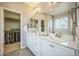 Modern bathroom with double sinks, white countertops, and a walk-in closet at 1261 W 170Th Ave, Broomfield, CO 80023