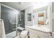 Modern bathroom featuring a glass-enclosed shower, a toilet, and a vanity with a white countertop at 1261 W 170Th Ave, Broomfield, CO 80023