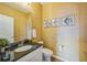 Stylish half-bath with textured walls, a toilet, and a vanity with black countertop and dark fixtures at 1261 W 170Th Ave, Broomfield, CO 80023