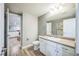 Clean bathroom with white cabinets, a vanity, and a view into the finished basement at 1261 W 170Th Ave, Broomfield, CO 80023