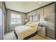 Charming bedroom with modern paneling, patterned curtains, and stylish bedside decor at 1261 W 170Th Ave, Broomfield, CO 80023