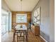 Cozy dining room featuring a wood-paneled wall, modern lighting, and a sliding glass door at 1261 W 170Th Ave, Broomfield, CO 80023