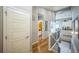 Bright hallway with hardwood floors, white trim, and an open floor plan leading to kitchen and staircase at 1261 W 170Th Ave, Broomfield, CO 80023