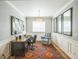 Well-lit home office with a wooden desk, accent chair, and stylish decor for a productive workspace at 1261 W 170Th Ave, Broomfield, CO 80023