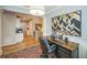 Comfortable home office featuring a large wooden desk, colorful rug, and decorative artwork at 1261 W 170Th Ave, Broomfield, CO 80023