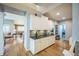 Modern open kitchen adjacent to the living room with sleek cabinets and countertops at 1261 W 170Th Ave, Broomfield, CO 80023