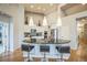 Modern kitchen island with pendant lighting, bar stools, and stainless steel appliances at 1261 W 170Th Ave, Broomfield, CO 80023