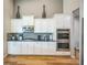 Modern kitchen with stainless steel appliances, granite countertops, and sleek white cabinets at 1261 W 170Th Ave, Broomfield, CO 80023