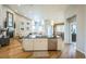 Kitchen island with stainless steel dishwasher and sink, open floor plan, pendant lights, and bar seating at 1261 W 170Th Ave, Broomfield, CO 80023