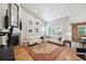 Bright living room features a fireplace, hardwood floors, a large comfy couch, and decorative wall art at 1261 W 170Th Ave, Broomfield, CO 80023
